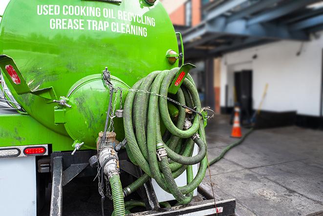 grease trap pumping truck in action in Commerce, CA